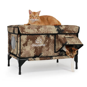 Two cats resting in insulated outdoor cat house with camouflage design, dual-entry for pets