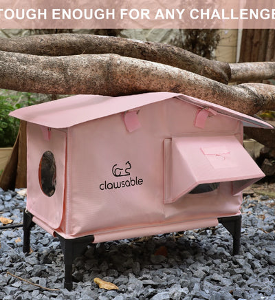 Load-bearing test of pink heated cat house showing durable structure